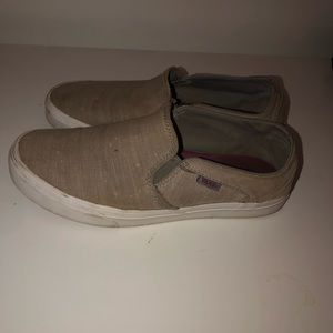 Worn down pair of gray slip on Vans